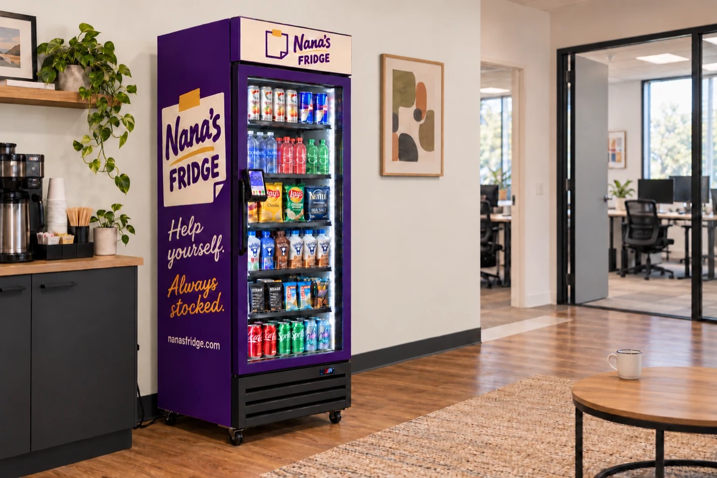 A purple Nana's Fridge stocked with drinks and snacks, next to the coffee station in a bright office lounge.